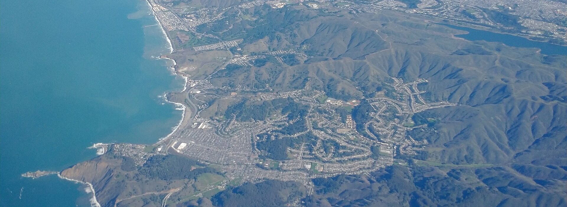 Aerial view of the Pacifica coastline, where the Peninsula hills meet the Pacific Ocean